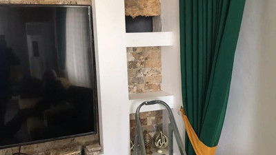 Aranan hükümlü evindeki gizli bölmede yakalandı